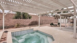 A covered outdoor swimming pool with a pergola overhead, surrounded by a brick wall and a patio area. - Fort Mohave Home w/ Hot Tub: 4 Mi to CO River! (Fort Mohave)