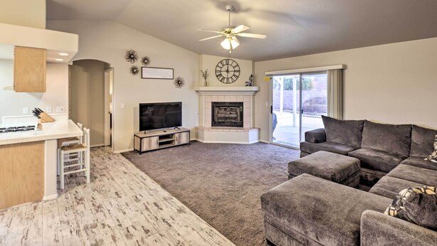 A living room with a fireplace, a television, and a sofa. - Fort Mohave Home w/ Hot Tub: 4 Mi to CO River! (Fort Mohave)