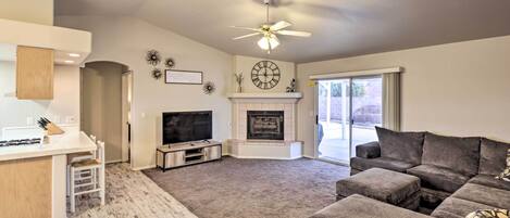 A living room with a fireplace, a television, and a sofa.
