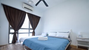 A bedroom with a bed, white nightstand, and a window with curtains. - GT Home Cascades Residency (Petaling Jaya)