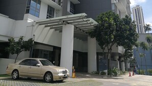 A modern high-rise building with a dark facade and white balconies. - GT Home Cascades Residency (Petaling Jaya)