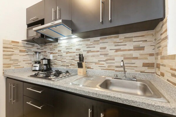 Fridge, microwave, coffee/tea maker, cookware/dishes/utensils