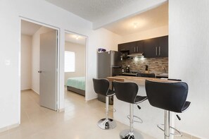 Fridge, microwave, coffee/tea maker, cookware/dishes/utensils