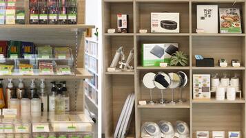 A retail store with shelves stocked with various products including skincare items, electronics, and household goods.
