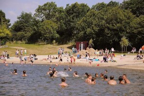 A crowded beach with people swimming and relaxing on the sand. - Luxury Villa in France with Private Pool (Les Forges)