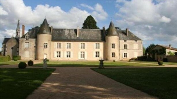 A large, historic building with a symmetrical facade, multiple towers, and a central entrance. - Luxury Villa in France with Private Pool (Les Forges)