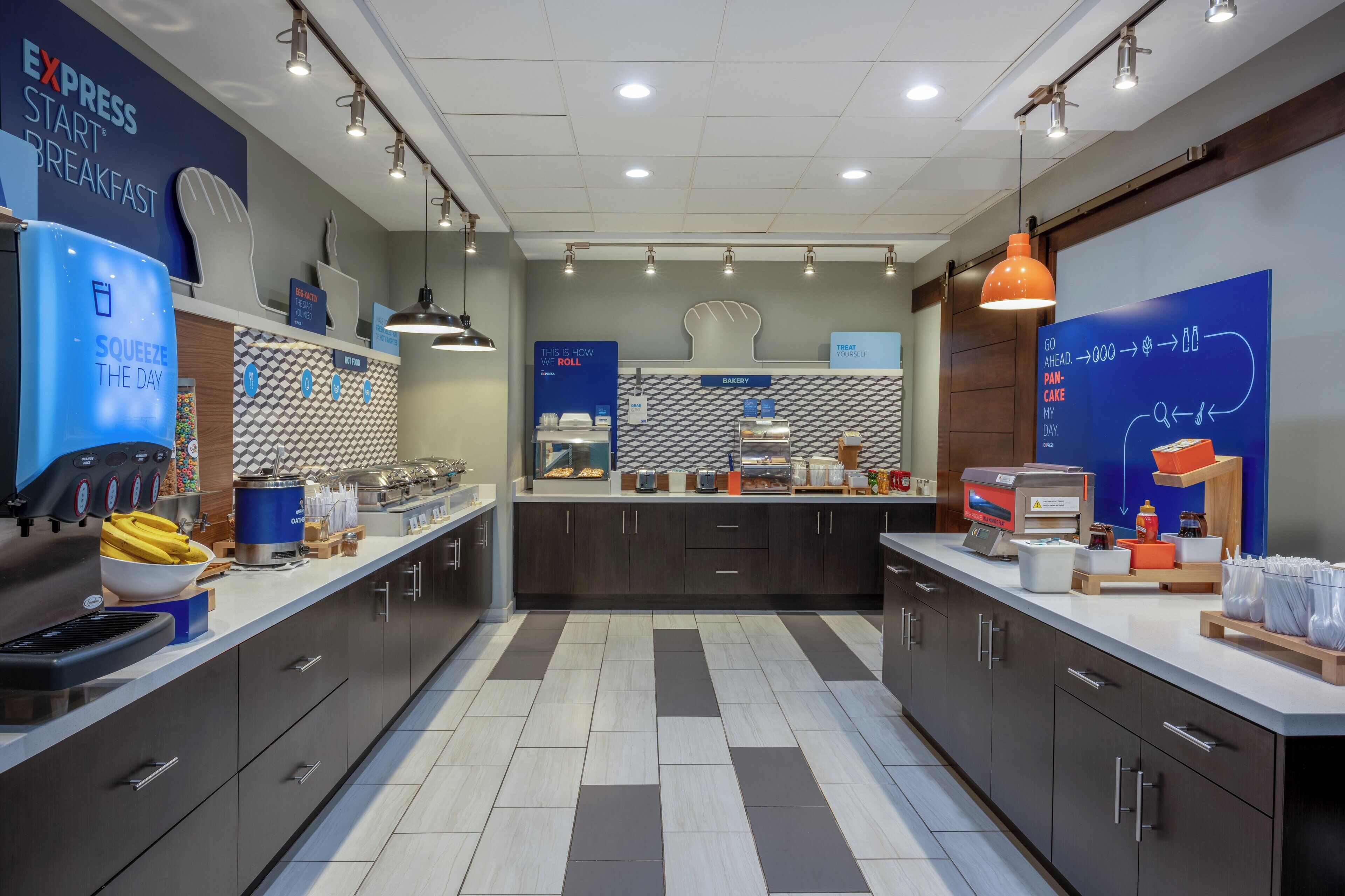 A modern breakfast area with a counter, seating, and a bakery section.