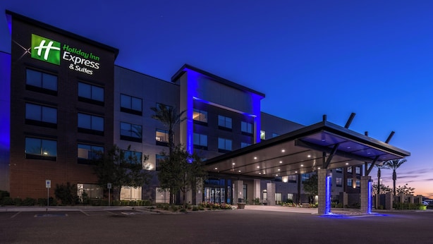 A Holiday Inn Express building with a modern design, featuring a covered entrance and a parking area.