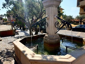 Stunning public fountain with a central column and flowing water.