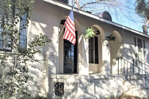 A building with a white facade, a black door, and an American flag. - Mins to ASU & Downtown- Foxy on Felder (Montgomery)