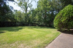 A well-maintained backyard with a lawn, a wooden fence, and dense foliage. - Mins to ASU & Downtown- Foxy on Felder (Montgomery)