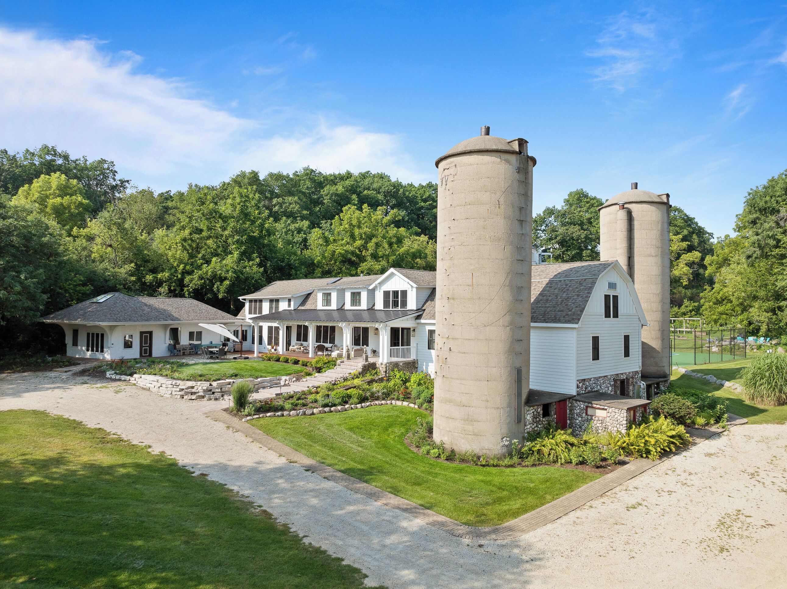A large estate with two prominent cylindrical silos, a main house, and a smaller structure.