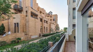 A residential building with multiple balconies, a tiled pathway, and greenery. - Playa Canela I - Punta del Moral Beach PPHC36P36 (Punta del Moral)