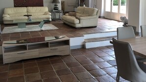 A spacious living room with two sofas, a coffee table, and a TV stand. - EXCEPTIONAL AND RARE, 15 km from MARSEILLE, BE 3 km FROM AUBAGNE, MAS DE STANDING (Roquevaire)