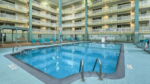 An indoor swimming pool with multiple levels of balconies, lounge chairs, and a covered seating area. - Pools, Tennis + Beach Access: Hilton Head Escape! (Hilton Head Island)