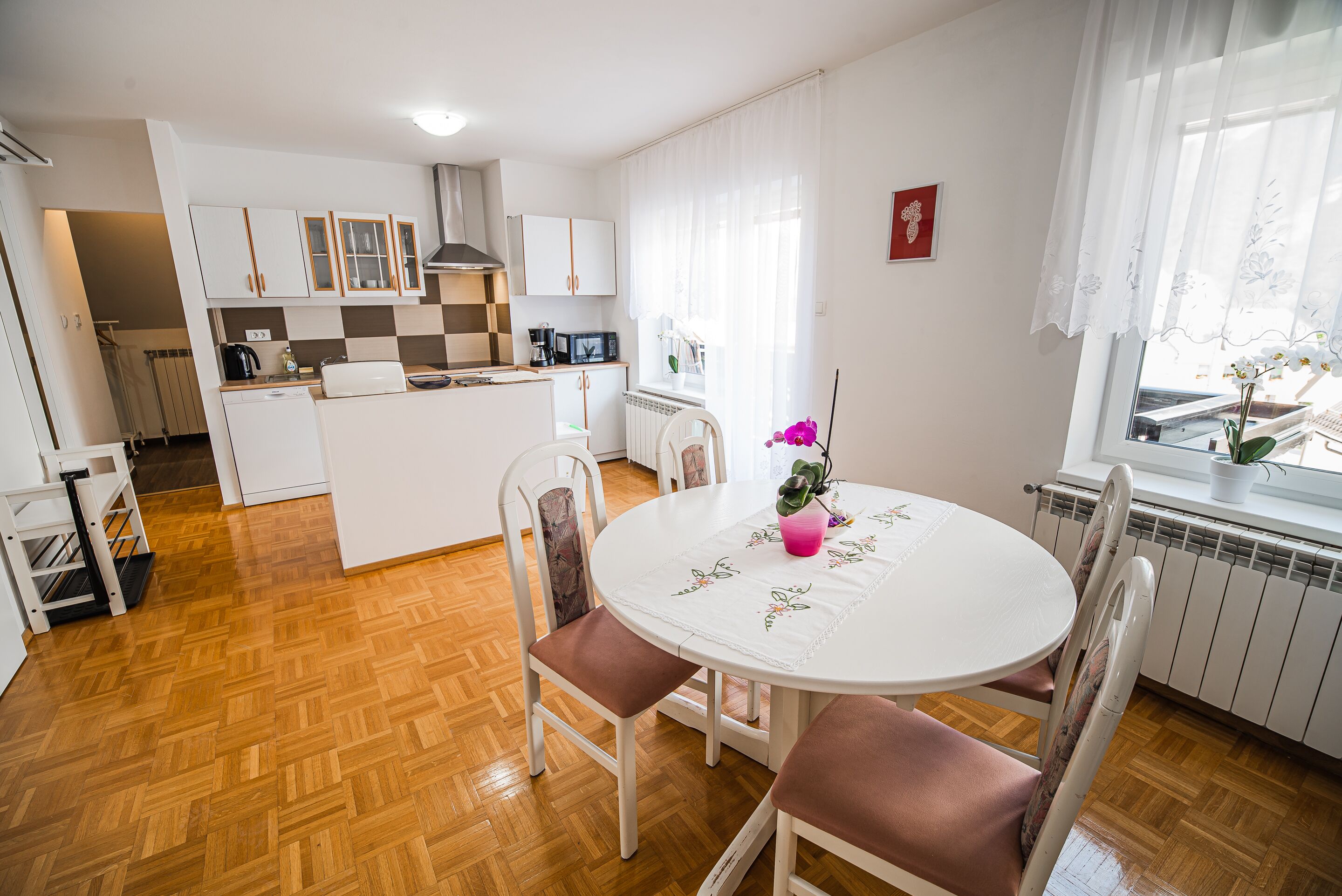 A compact kitchen with white cabinets, a microwave, and a coffee maker.