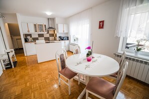 A compact kitchen with white cabinets, a microwave, and a coffee maker. - Vila K29 (Bovec)