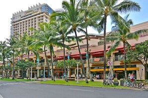 A hotel with multiple floors, outdoor seating areas, and a pedestrian walkway. - 11th Floor Waikiki Ocean, Lagoon & Marina Views! Walk to Beach! Washlet! (Honolulu)
