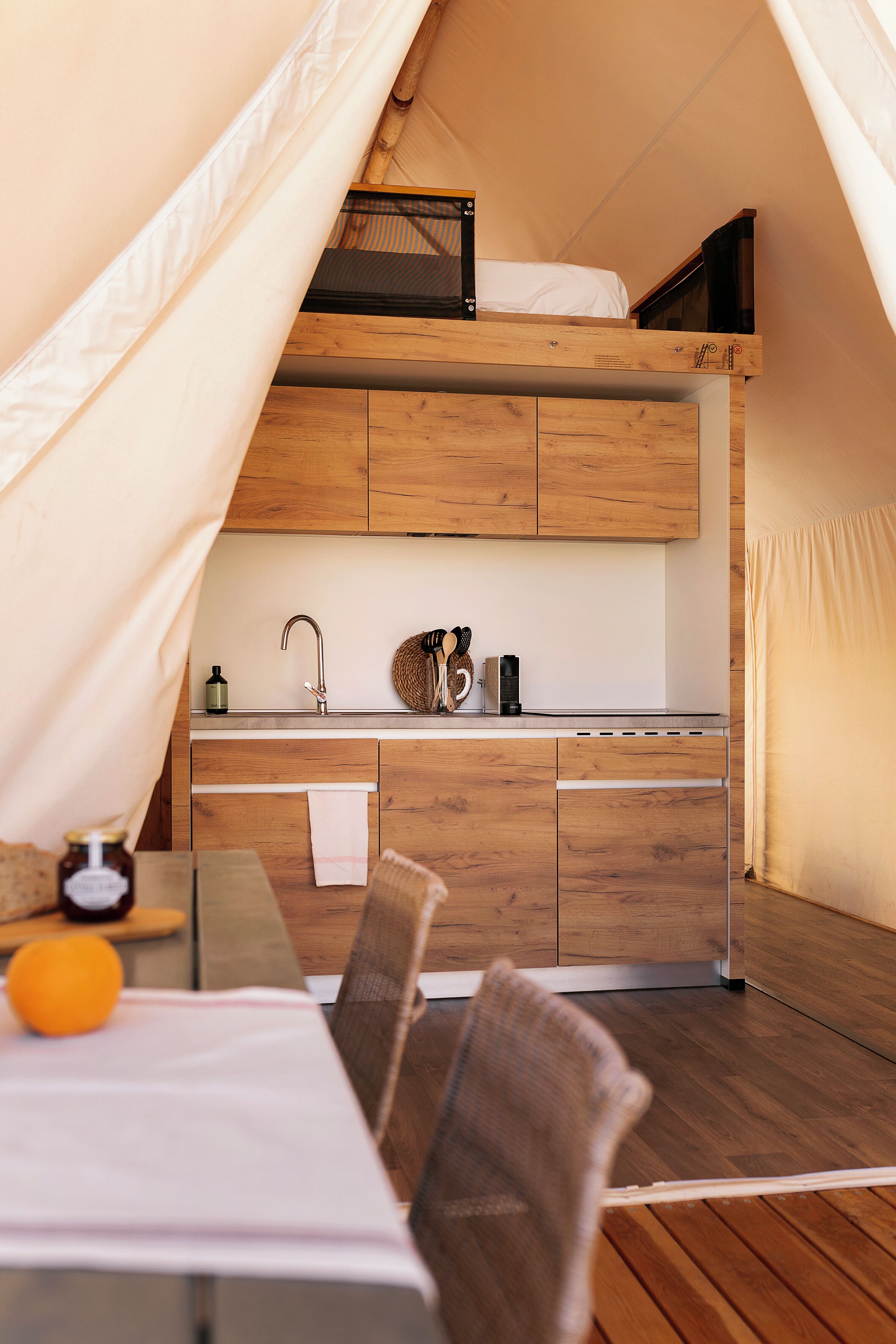 A cozy kitchenette with wooden cabinets, a sink, and a small countertop.