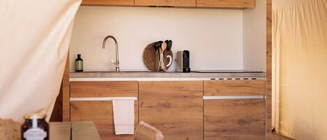 A cozy kitchenette with wooden cabinets, a sink, and a small countertop.
