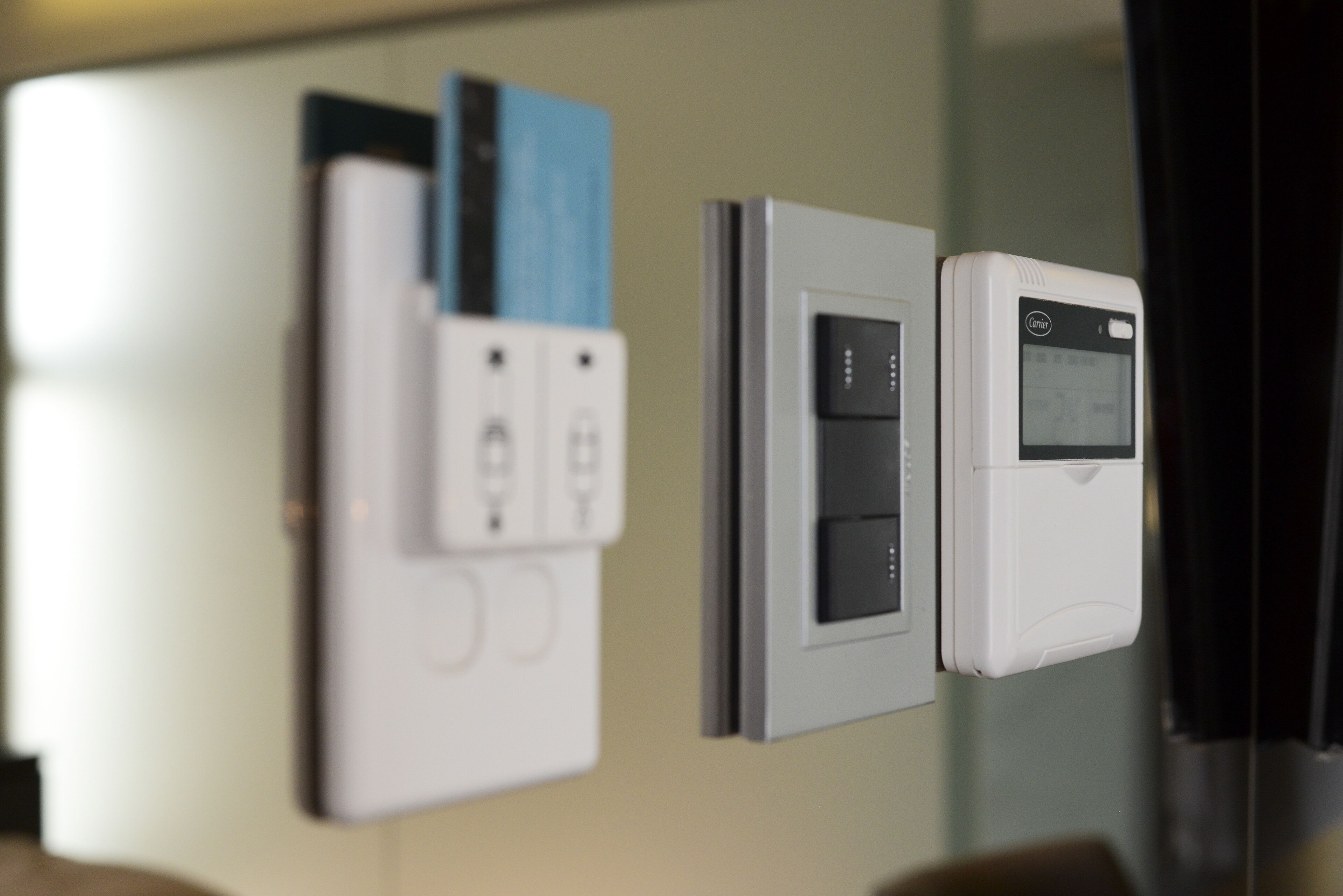 A wall-mounted control panel with various switches and a digital display.