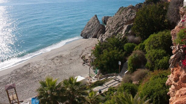 A coastal view with a beach, rocky cliffs, and a staircase leading down to the beach. - South Apartment, in Torrecilla Nerja (Nerja)