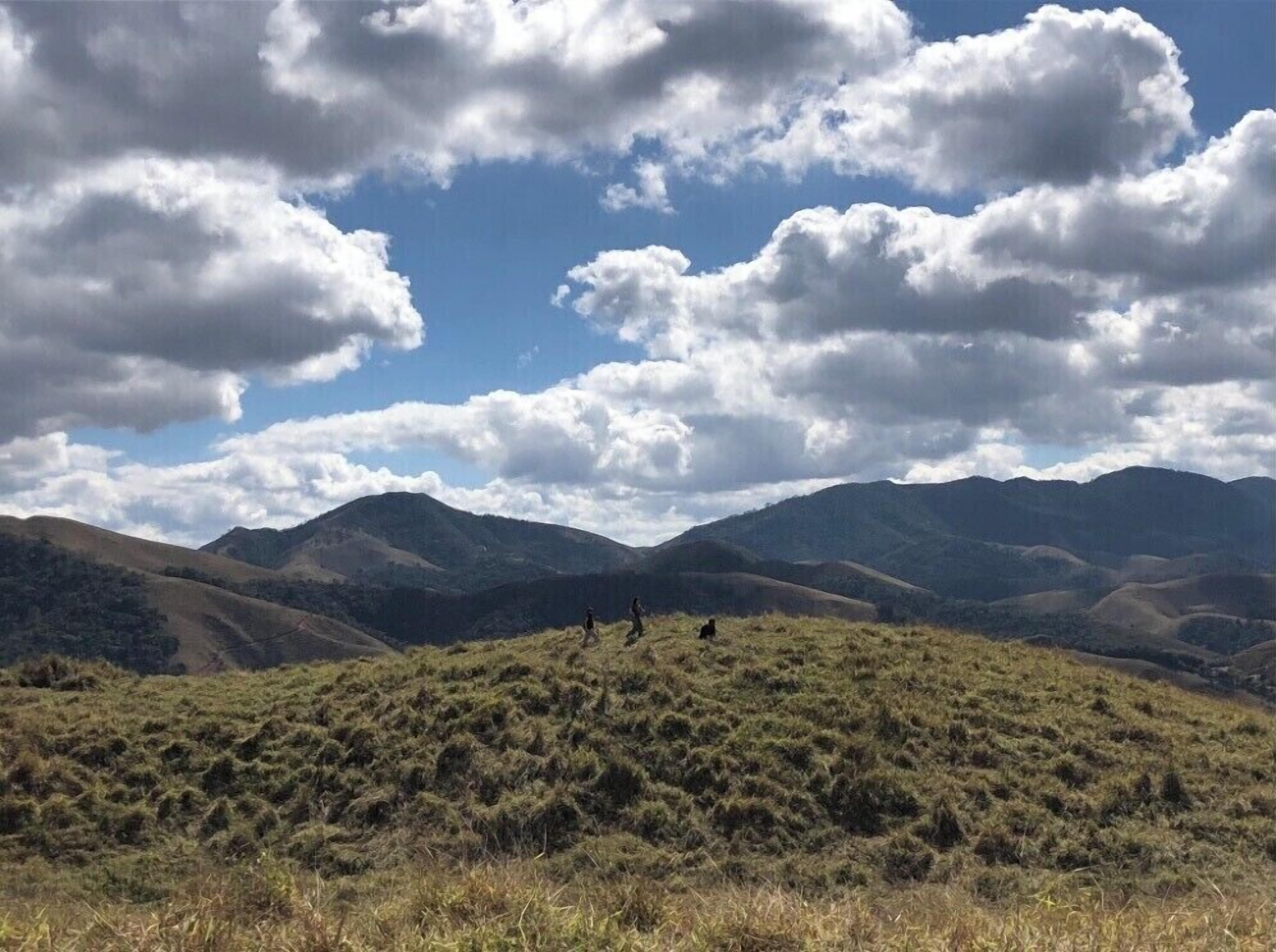 Un paisaje montañoso con colinas ondulantes y cielo despejado.