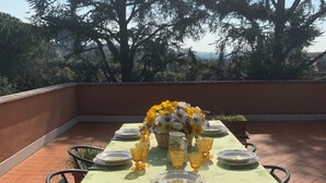 A table set outdoors with a green tablecloth, yellow flowers, and clear glassware. - Villa Capri Bernabei, Domus Romana with private swimmingpool (Ciampino)