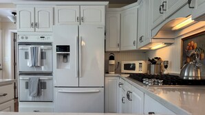 A kitchen with white cabinetry, a built-in oven, a refrigerator, a microwave, and a gas stove. - Beach nearby-pure summer/winter magic awaits! (Genoa City)
