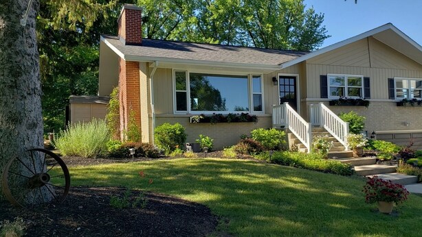 A single-story house with a front porch, a garage, and a well-maintained lawn. - Beach nearby-pure summer/winter magic awaits! (Genoa City)