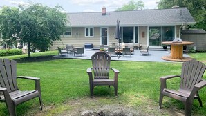 A backyard with a covered patio, outdoor furniture, and a fire pit. - Beach nearby-pure summer/winter magic awaits! (Genoa City)