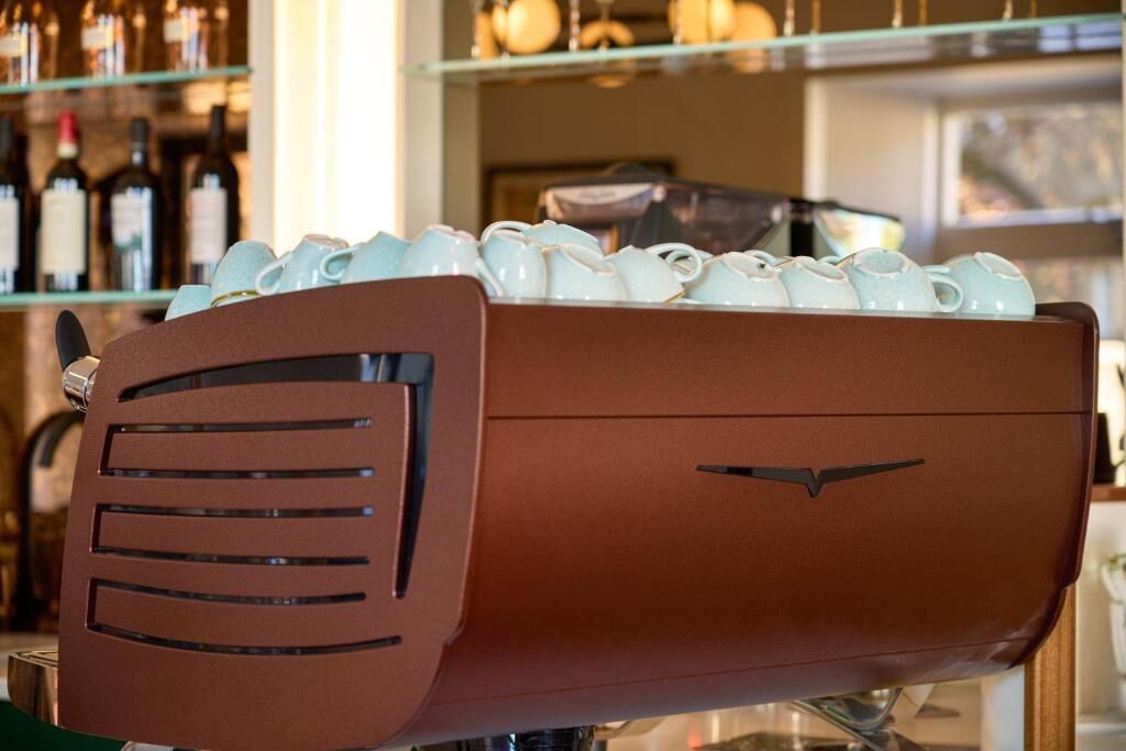 A coffee machine with a brown exterior and a logo on the front.