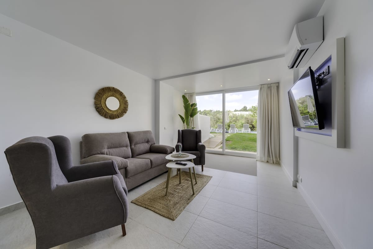 Luxury Suite, 1 Bedroom, Poolside | Living area | Flat-screen TV