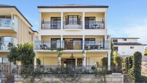 A multi-story building with balconies, a covered entrance, and a sign reading "The River Suite". - River Suite.  Rest, Revitalise, Relax (Maylands)