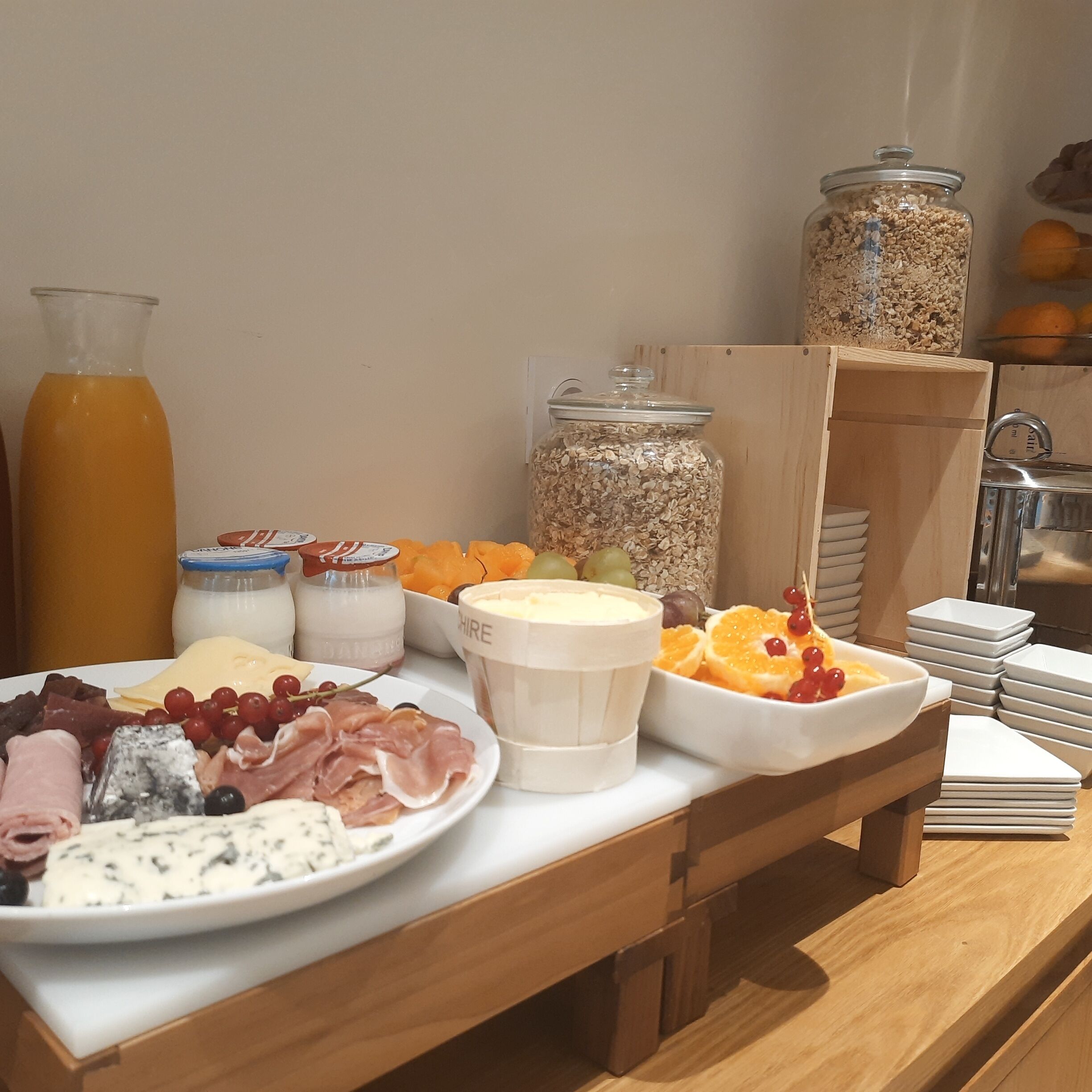 A breakfast buffet with various food items and beverages.