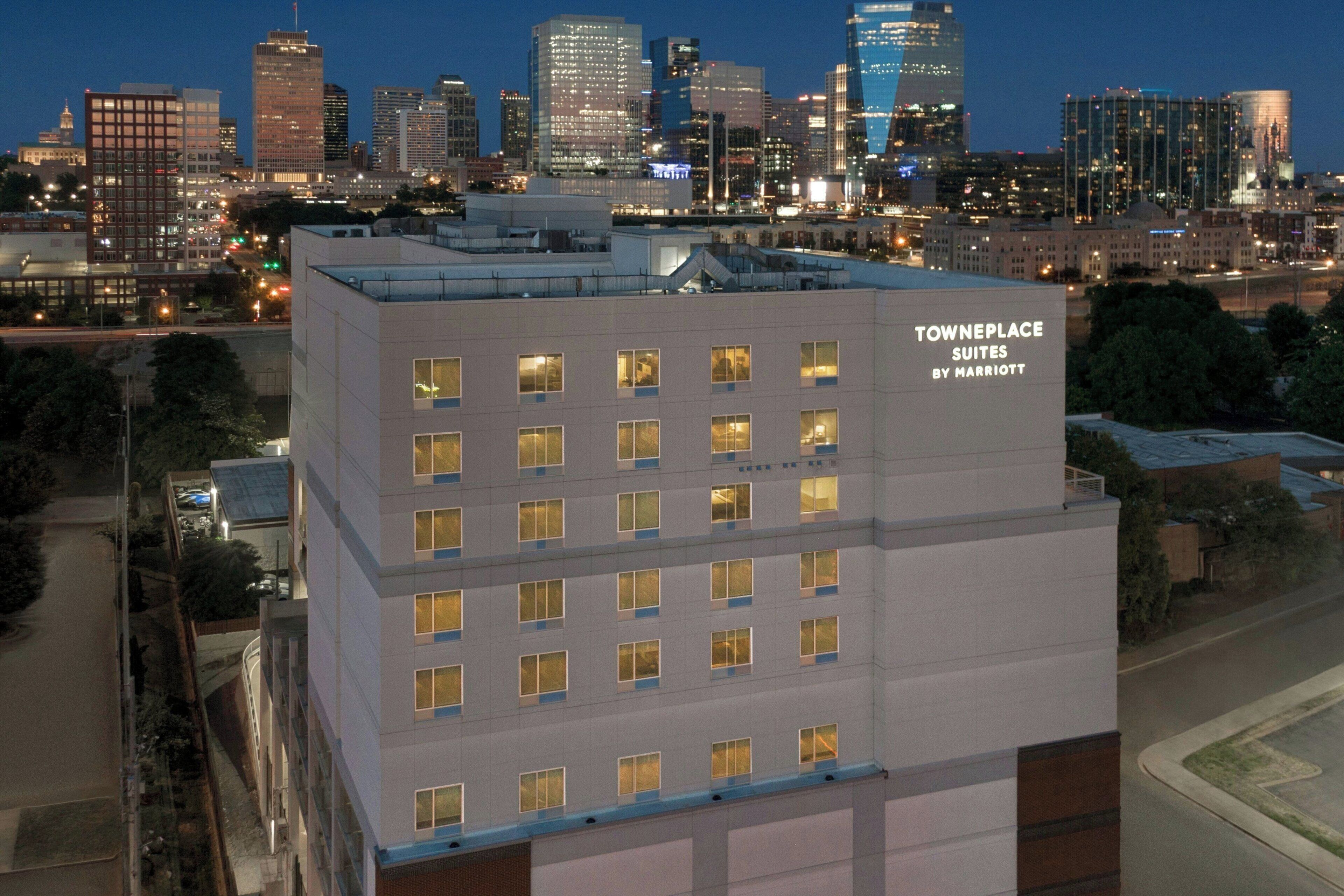 A multi-story hotel building with a sign indicating it is a TownePlace Suites by Marriott.