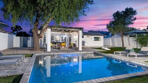 A modern outdoor pool area with a clear view of the backyard, including a patio with seating and a barbecue area. - 5 Min to Old Town • Heated Pool • Hot Tub • Fire Pit (Scottsdale)