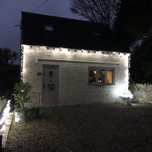 Step into this charming cottage with a welcoming entrance, complete with a cozy porch and a window into the interior.