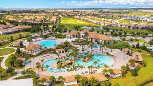 A resort with multiple swimming pools, a golf course, and residential buildings. - 8 Bedroom Home inside the best resort in Orlando, GOLF VIEW! (Four Corners)
