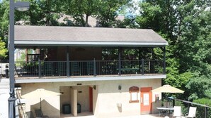 A two-story building with a balcony, outdoor seating area, and a swimming pool. -  2 minutes to Parkway, 5 minutes to The Island & Dollywood!  (Pigeon Forge)