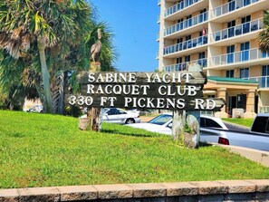 A sign for the Sabine Yacht Racquet Club at 330 FT Pickens Rd.