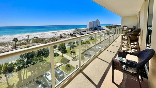 A balcony with a view of the beach and ocean. - Sabine 6E- Sleeps 6 Gulf View Pensacola Beach Condo (Pensacola Beach)