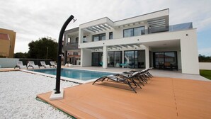 A modern two-story house with a swimming pool, outdoor seating, and a pergola. - Villa Vagabundo with Pool (Zaton)