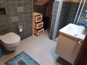A bathroom with a toilet, a sink, a shower, and storage cabinets. - Beautiful 3-bed Villa in Zaton Mali (Dubrovnik)
