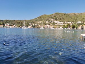A coastal town with clear blue waters, boats, and buildings on a hillside. - Beautiful 3-bed Villa in Zaton Mali (Dubrovnik)