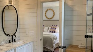 A bedroom with a bed, a bedside table, and a mirror. - Water views & only 2 miles to downtown  (Charleston)