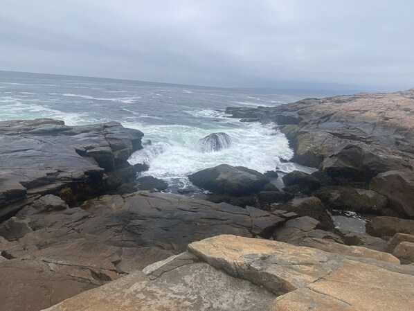 A rocky coastline with waves crashing against the rocks.