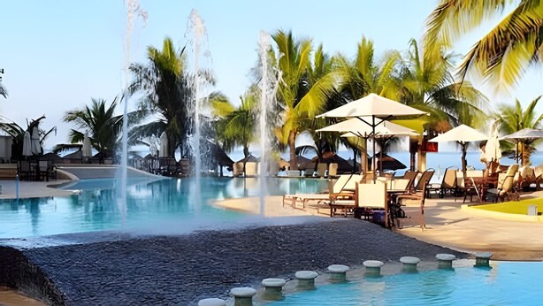 A pool with water jets, lounge chairs, umbrellas, and palm trees. - 302 S Bay View Grand Residencial Ixtapa (Ixtapa)
