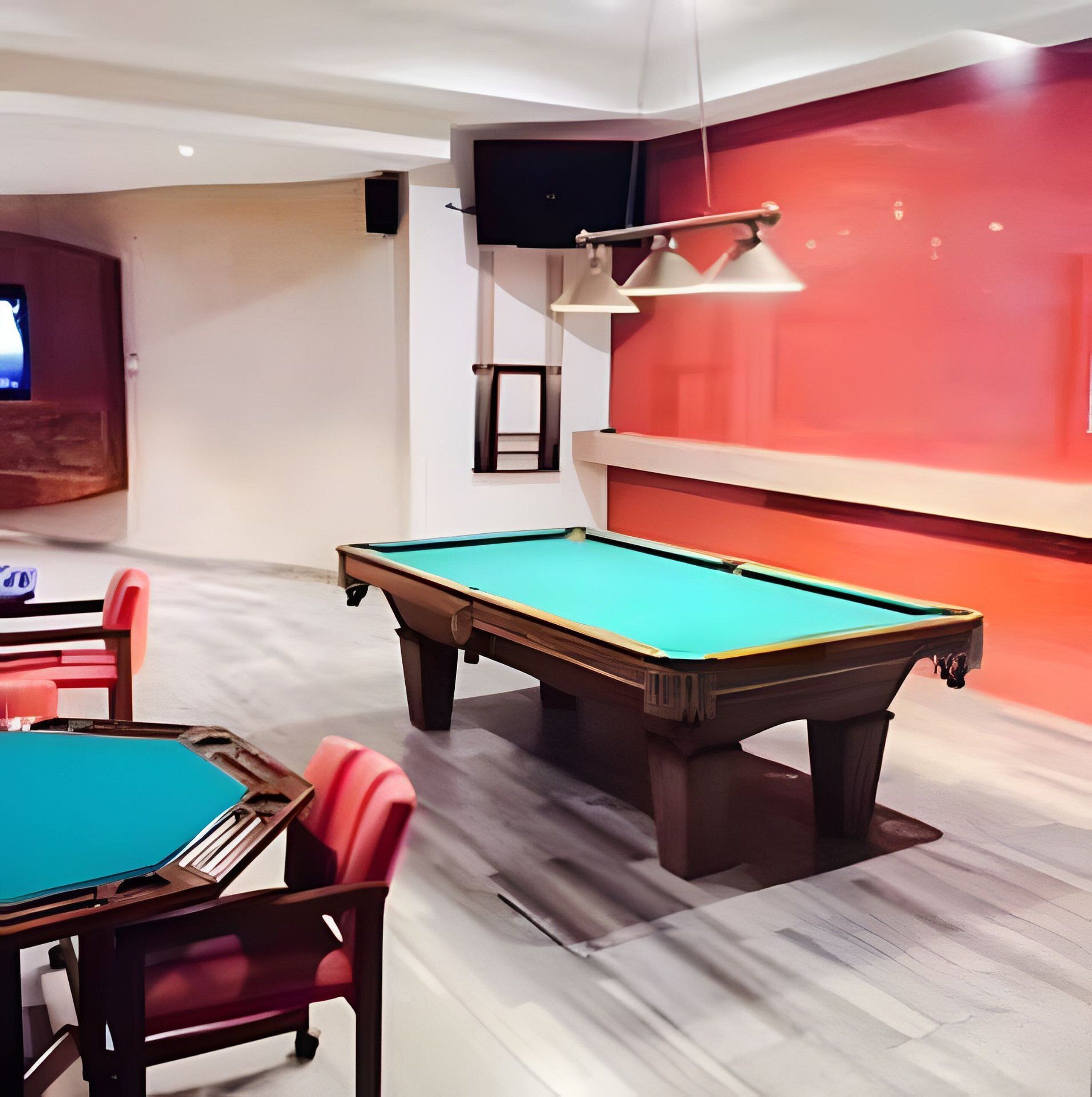 A pool table in a room with a red accent wall, a television, and a ceiling-mounted lamp.