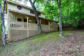 A wooden cabin with a covered porch, surrounded by trees. - Almost Heaven - Minutes to the Parkway!! (Pigeon Forge)